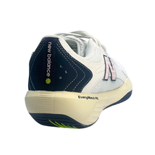 Back view of a New Balance ladies pickleball shoe. Suitable for tennis, pickleball and netball. Has a white mesh upper with a pink N and Navy heel and sole.