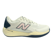 Side view of a New Balance ladies pickleball shoe. Suitable for tennis, pickleball and netball. Has a white mesh upper with a pink N and Navy heel and sole.