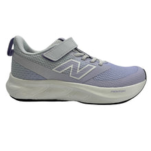 A New Balance kids' running shoe in light purple and gray, featuring a hook-and-loop strap closure, a large 'N' logo on the side, and a thick white cushioned midsole.