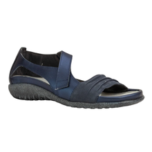 The Noat Papaki. A women's open-toe slip-on sandal in navy blue, featuring a textured dark gray wedge sole and a wide adjustable strap with a velcro closure. Mae with a cork and latex removable insole.