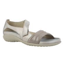 The Noat Papaki. A women's open-toe slip-on sandal in light metallic grey, featuring a textured light grey wedge sole and a wide adjustable strap with a velcro closure. Mae with a cork and latex removable insole.