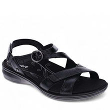 A black women's strappy sandal with an adjustable ankle strap, a decorative circular buckle, and floral details on the footbed. Footbed is removable for use of an orthotic.