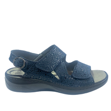 Simply Comfort Maddie. An adjustable three strap sandal with velcro on the front straps and a buckle on the heel. Features a soft removable insole. Orthotic friendly with a solid stable sole.