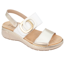 Suave dive. A women's orthotic friendly open-toe wedge sandal with gold and white straps, a gold-tone double-ring buckle detail, and a beige cushioned insole and sole.